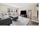 Bright living room with wood floors, cozy furniture, and stylish tile surrounding the fireplace at 2263 E 129Th Ave, Thornton, CO 80241