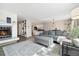 Bright living room with a modern gray sofa and an inviting fireplace at 2263 E 129Th Ave, Thornton, CO 80241