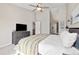 Bright main bedroom features a ceiling fan, tv, closet, and doorway leading to the main bathroom at 2263 E 129Th Ave, Thornton, CO 80241