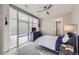 Comfortable bedroom featuring a window with blinds, a modern ceiling fan, and stylish furnishings at 4200 W 17Th Ave # 1013, Denver, CO 80204
