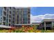Modern building exterior surrounded by colorful flowers, blending nature with contemporary architecture at 4200 W 17Th Ave # 1013, Denver, CO 80204