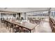 Spacious dining area with a large communal table and an open floor plan with a kitchen and patio at 4200 W 17Th Ave # 1013, Denver, CO 80204