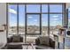 Living room featuring floor-to-ceiling windows showcasing stunning city skyline views and comfortable seating at 4200 W 17Th Ave # 1013, Denver, CO 80204