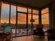 Modern living room showcasing expansive windows with breathtaking sunset views of the city skyline at 4200 W 17Th Ave # 1013, Denver, CO 80204