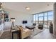 Modern living room with a large window showcasing city views, stylish furniture, and contemporary decor at 4200 W 17Th Ave # 1013, Denver, CO 80204
