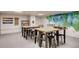 Well-lit studio space with tables, chairs, and a colorful mural, fostering creativity and collaboration at 4200 W 17Th Ave # 1013, Denver, CO 80204
