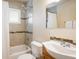 Cozy bathroom with shower, tiled tub, and a vanity with sink at 10500 Marion St, Northglenn, CO 80233