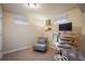 Bright bedroom with carpet flooring and an office desk with white chair at 10500 Marion St, Northglenn, CO 80233