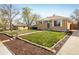 Well-maintained home with a detached garage, green lawn, and mature trees at 10500 Marion St, Northglenn, CO 80233
