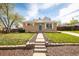 Charming brick home featuring a well-manicured lawn and inviting walkway at 10500 Marion St, Northglenn, CO 80233