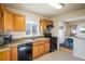 Functional kitchen with wooden cabinets, granite countertops, and modern appliances at 10500 Marion St, Northglenn, CO 80233