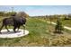Outdoor community art featuring a majestic buffalo sculpture on a grassy knoll at 10500 Marion St, Northglenn, CO 80233