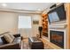 Finished basement area with fireplace, TV, and comfortable seating at 7701 Rollins Dr, Larkspur, CO 80118