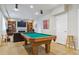Finished basement area with pool table, fireplace, and bar for entertaining at 7701 Rollins Dr, Larkspur, CO 80118