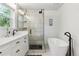Beautiful bathroom with walk-in shower, modern vanity, and freestanding soaking tub at 7701 Rollins Dr, Larkspur, CO 80118