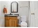Bathroom featuring wood vanity with a dark countertop, a mirror, and a toilet at 7701 Rollins Dr, Larkspur, CO 80118