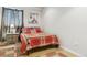 Cozy bedroom featuring a bed with red plaid bedding and a Paris-themed artwork at 7701 Rollins Dr, Larkspur, CO 80118