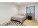 Bedroom offers a comfortable bed, patterned curtains and a geometric rug at 7701 Rollins Dr, Larkspur, CO 80118