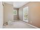 Neutral bedroom has two windows letting in natural light at 7701 Rollins Dr, Larkspur, CO 80118