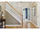 Inviting foyer featuring hardwood floors and staircase at 7701 Rollins Dr, Larkspur, CO 80118