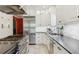 Gourmet kitchen with stainless steel oven, tile backsplash, and white cabinets at 7701 Rollins Dr, Larkspur, CO 80118