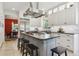 Gourmet kitchen with stainless appliances, modern white cabinets, and large center island at 7701 Rollins Dr, Larkspur, CO 80118