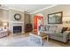Cozy living room with fireplace, neutral walls, hardwood floors and modern furniture at 7701 Rollins Dr, Larkspur, CO 80118