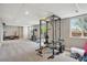 Finished basement with home gym area and sliding glass door to the backyard at 4915 Parsons Way, Castle Rock, CO 80104