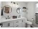 Stylish bathroom featuring double sinks, round mirrors and modern black accents at 4915 Parsons Way, Castle Rock, CO 80104