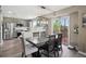 Bright dining area with table and chairs, hardwood floors, sliding door to patio and open to kitchen at 4915 Parsons Way, Castle Rock, CO 80104