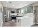 Well-lit kitchen with updated stainless steel appliances, white countertops and sage green cabinets at 4915 Parsons Way, Castle Rock, CO 80104
