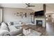 Inviting living room with hardwood floors, fireplace, built-in shelves, and comfortable sectional sofa at 4915 Parsons Way, Castle Rock, CO 80104