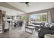 Open-concept living space with hardwood floors, eat-in kitchen and comfortable gray sectional sofa at 4915 Parsons Way, Castle Rock, CO 80104
