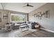 Bright living room with hardwood floors, large window, and comfortable gray sectional sofa at 4915 Parsons Way, Castle Rock, CO 80104