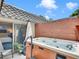 Backyard features a hot tub, a brick wall, and an outdoor lounge space at 3481 S Race St, Englewood, CO 80113