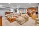 Finished basement featuring a sectional sofa, a coffee table, and built-in shelving with a desk at 3481 S Race St, Englewood, CO 80113
