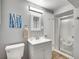 Neutral bathroom features updated sink, cabinet, lighting, and tiled floor at 3481 S Race St, Englewood, CO 80113