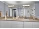 Bathroom featuring double sinks, modern fixtures, a glass shower, and a large mirror at 3481 S Race St, Englewood, CO 80113