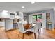 Open dining area adjacent to a modern kitchen, featuring hardwood floors and access to an outdoor space at 3481 S Race St, Englewood, CO 80113