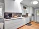 Contemporary kitchen featuring sleek white cabinets, modern appliances, and a breakfast bar with seating at 3481 S Race St, Englewood, CO 80113