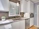 Bright kitchen with stainless steel appliances, tiled backsplash, and white cabinets at 3481 S Race St, Englewood, CO 80113
