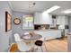 Modern kitchen with a breakfast nook, white cabinetry, stainless steel appliances, and a skylight at 3481 S Race St, Englewood, CO 80113