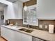 Bright kitchen with stainless steel appliances, tiled backsplash, white cabinets, and light countertops at 3481 S Race St, Englewood, CO 80113