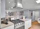 Modern kitchen with stainless steel stove, light countertops, view to living room and open floor plan at 3481 S Race St, Englewood, CO 80113