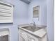 Laundry room with stainless steel sink, light countertop, and white cabinets at 3481 S Race St, Englewood, CO 80113