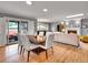 Open floor plan with a dining room, living room with fireplace, and access to a patio at 3481 S Race St, Englewood, CO 80113