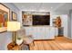 Entertainment area featuring built-in shelving, a wine fridge, cabinets, and a wall mounted TV at 3481 S Race St, Englewood, CO 80113