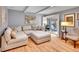 Bright living room featuring a comfortable sectional sofa, hardwood floors, and sliding glass door to the outside at 3481 S Race St, Englewood, CO 80113