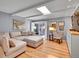 Open living room with skylight, a comfortable sectional sofa, hardwood floors, and sliding glass door at 3481 S Race St, Englewood, CO 80113