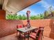 Relaxing outdoor patio with a dining table and shade umbrella, surrounded by a brick privacy wall at 3481 S Race St, Englewood, CO 80113